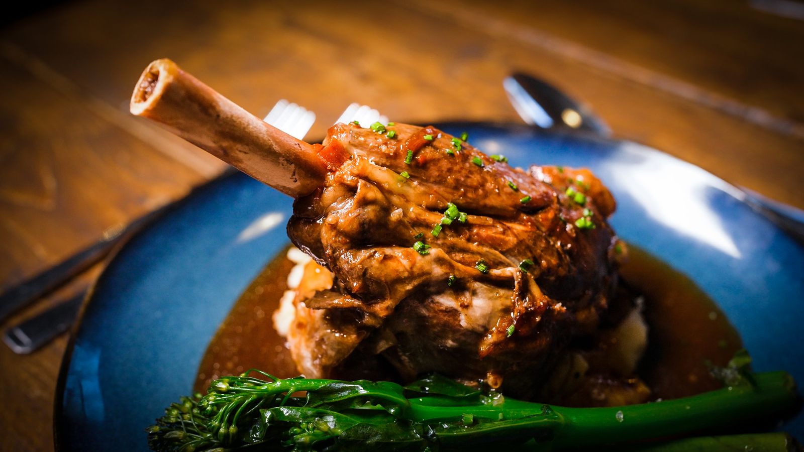 Slow-braised lamb shank with rich gravy and tenderstem broccoli